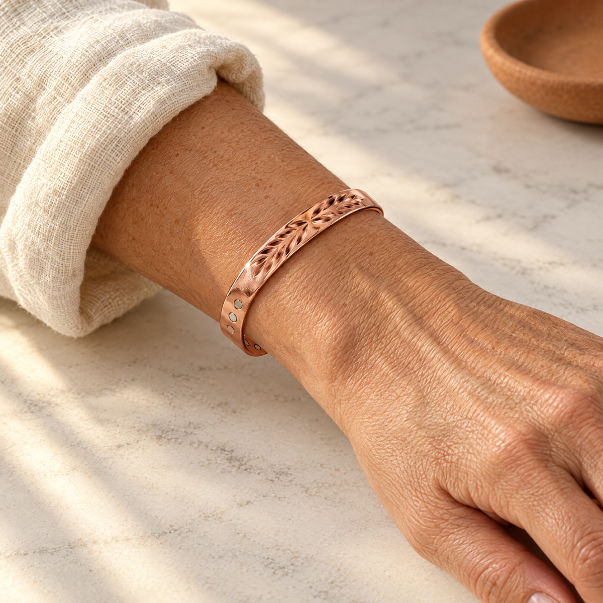 June's Lunar Copper Bracelet – pure copper bracelet on a warm neutral background - photo 2