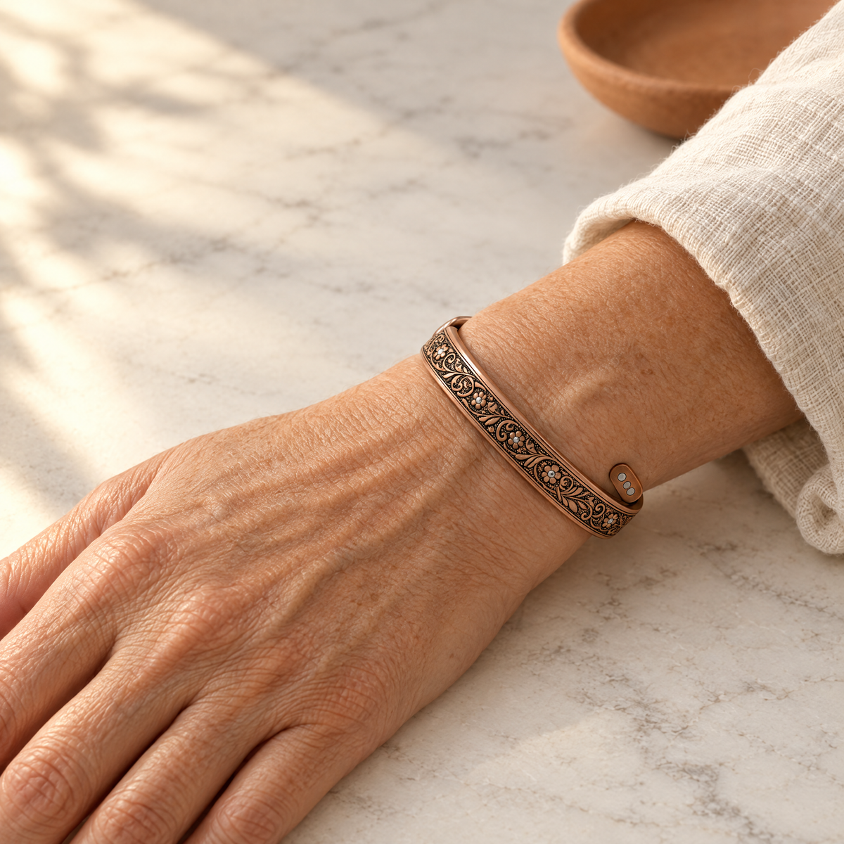 June's Sprig Copper Bracelet – pure copper bracelet on a warm neutral background - photo 2