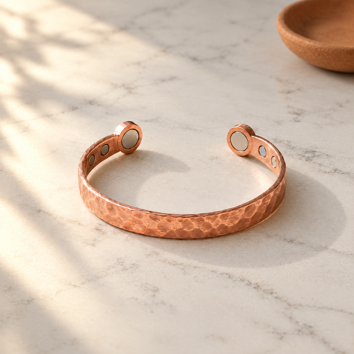 June's Lodestone Copper Bracelet – pure copper bracelet on a warm neutral background - photo 1